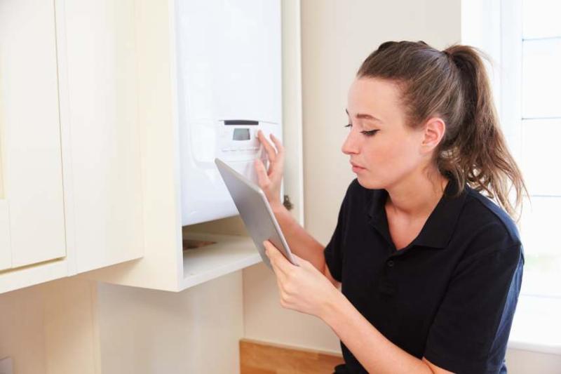 tradesperson fixing a boiler