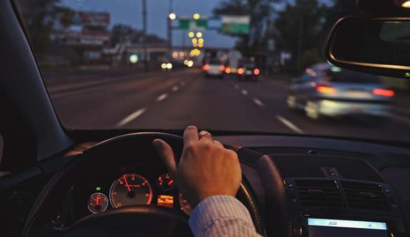 Image of a woman driving at night
