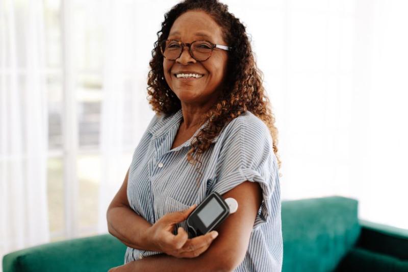 Woman using a flash glucose monitor