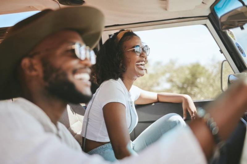 Couple driving in car in the sun