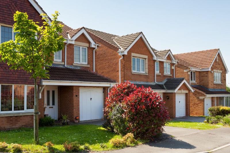 A row of terraced houses with trees at the front