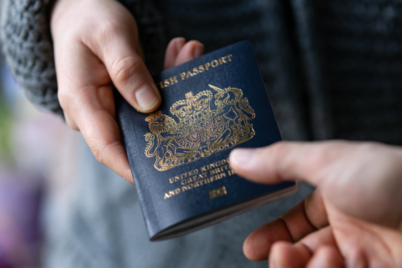 person handing their passport to someone else