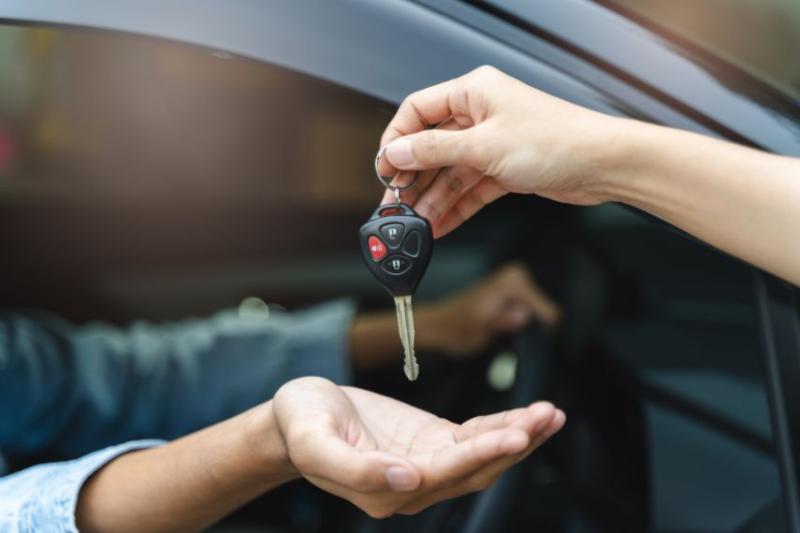 Passing a set of car keys into someone's hand
