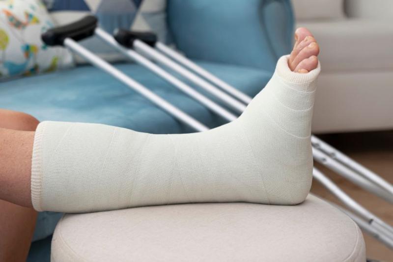 person wearing cast on leg resting on furniture