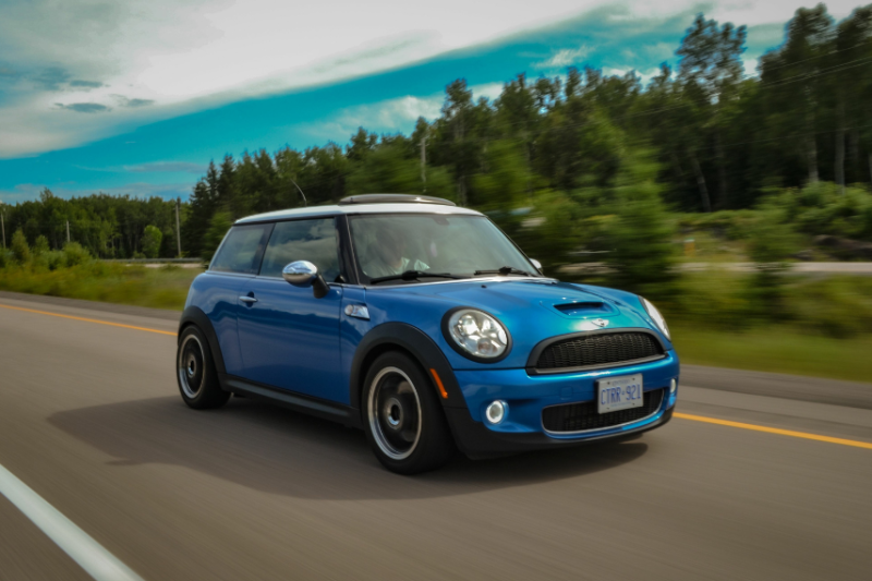 blue mini cooper driving on country road