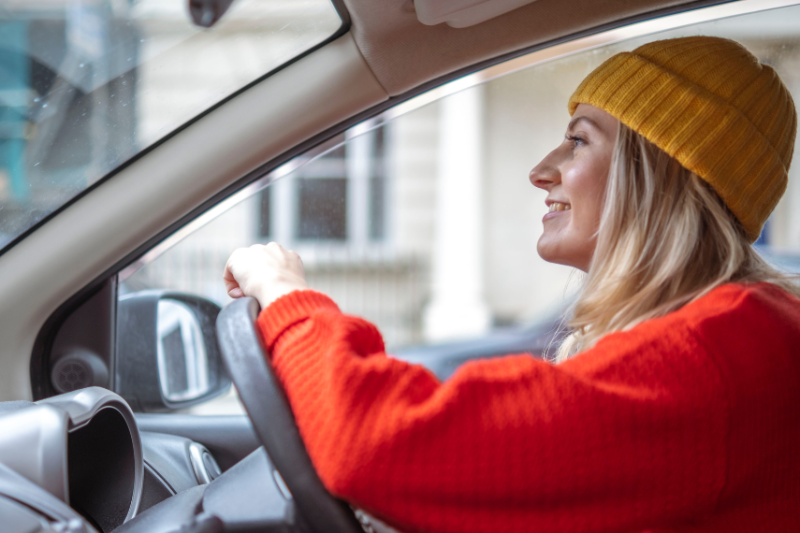 woman driving in car wearing jumper