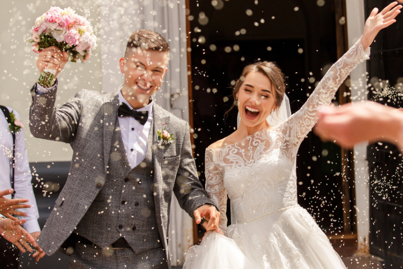 couple celebrating wedding with confetti