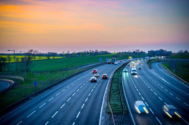 View of a UK motorway, with sunrise in the background