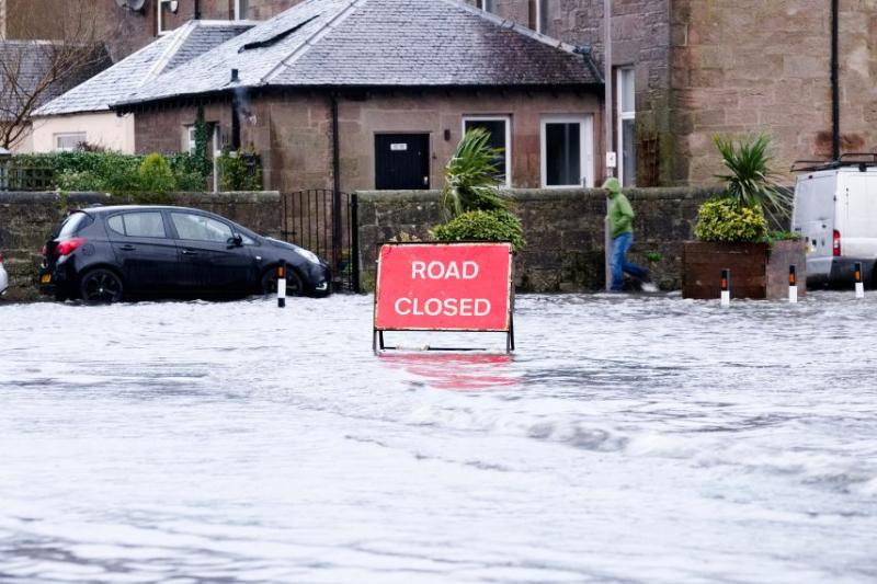photo of road closure sign on flooded road