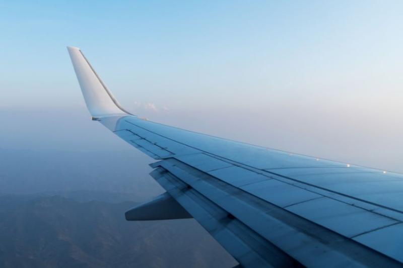 image of plane wing in sky