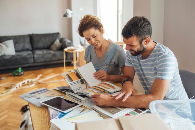 A couple looking over paint swabs and planning home renovations