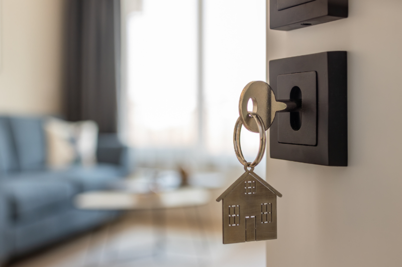 image of key in door with house keyring attached