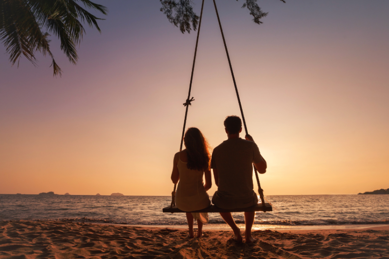 picture of a couple on a beach during sunset