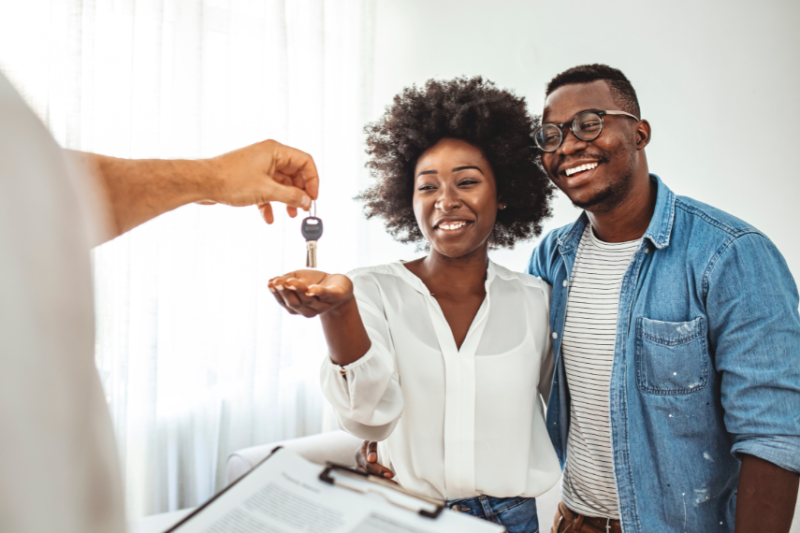 couple receiving keys to new home