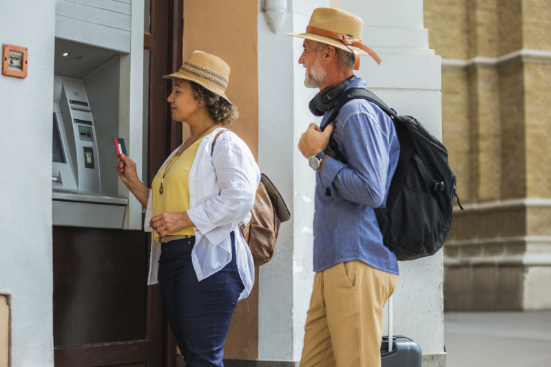 couple at ATM taking out cash
