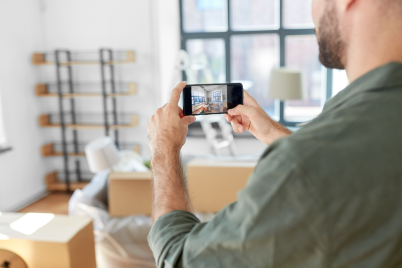 Man taking a picture of his home