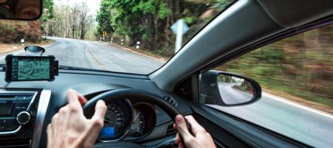 man-driving-with-phone-on-dashboard