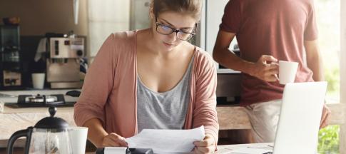 woman-budgeting-kitchen-table