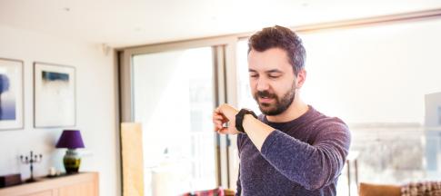 man-using-his-smart-watch