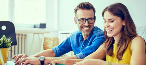 couple-sitting-at-a-table-organising-their-finances