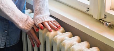a-womans-hands-on-radiator