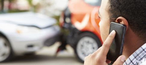 man-using-a-mobile-phone-to-report-an-accident