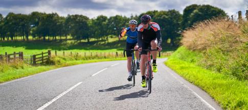 two-cyclists-on-a-country-road