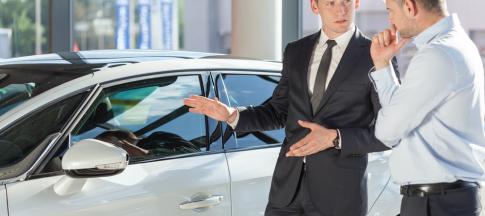 car-salesman-showing-a-car-to-a-man