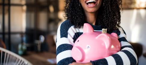 Woman hugging piggy bank