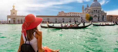 A woman sitting on a bay in Venice