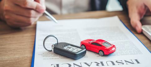 car-insurance-documents-with-car-key-and-model-car