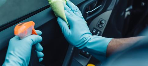 Person cleaning car dashboard