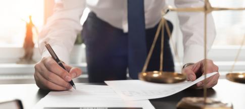 solicitor working on documents at desk