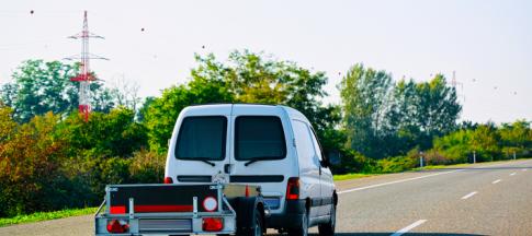 small van towing a trailer