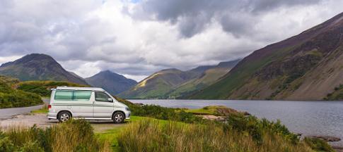 Campervan parked by lake