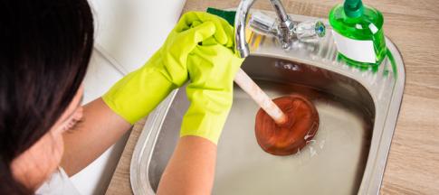 unblocking a sink with a plunger