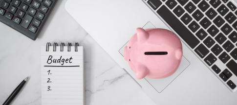 notebook and piggy bank on laptop