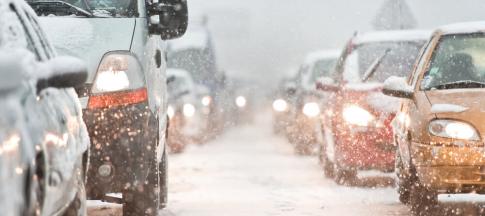 cars in a queue in snowy conditions
