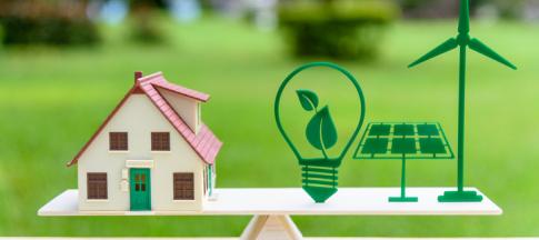 image of miniature home on scales with eco icons