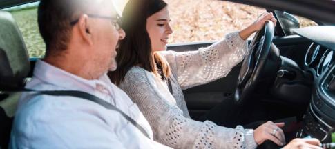 Image of a learner driver in a car with her instructor