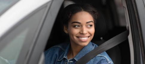 Image of a black woman driving a car.