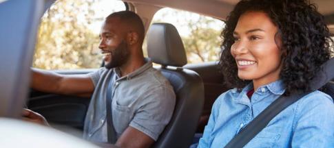 Image of an adult couple driving a car.