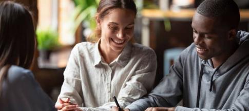 Image of a happy couple signing referencing forms