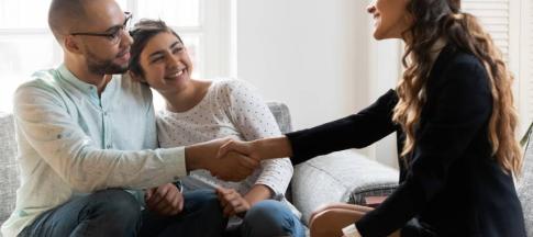 Image of a landlord and a couple after signing a rental agreement