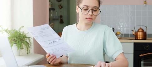 image of a woman paying her car insurance bills