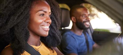 Image of a couple in a car with the woman driving