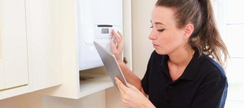 tradesperson fixing a boiler