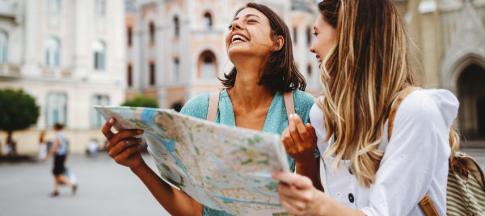 Two women looking at map and smiling