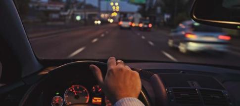 Image of a woman driving at night