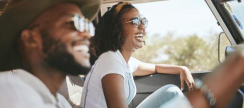 Couple driving in car in the sun